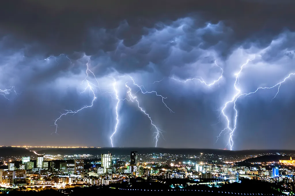 Lightning storm over city — hurricane and storm damage billing Florida